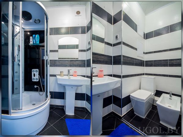 Помещение с душевой, раковиной и отдельной зоной с унитазом и биде, оформленное полосатыми плитками.